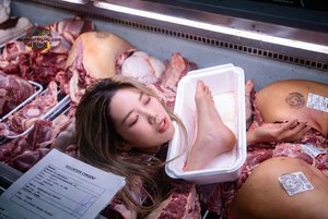 Woman in Meat Display
