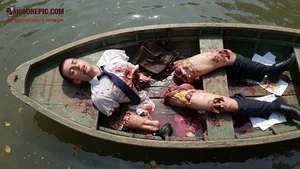 Mangled Businessman in Bloody Boat
