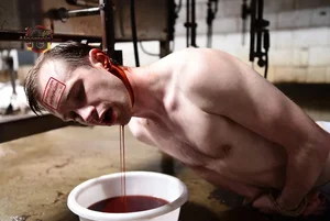 Man Bleeding into Bucket